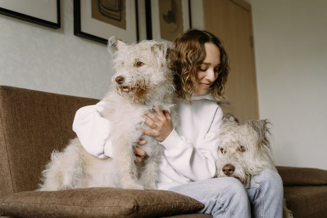 Helene relaxing on the couch with two happy dogs